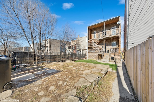 view of yard featuring stairway, a fenced backyard, and a deck