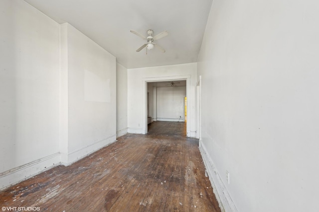 interior space with hardwood / wood-style floors, a ceiling fan, and baseboards