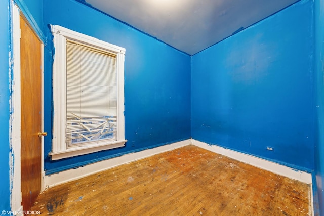 unfurnished room with hardwood / wood-style flooring