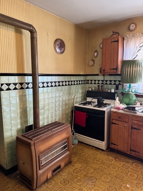 kitchen with tile walls and gas range gas stove