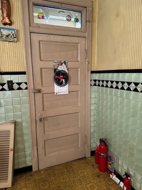 doorway with tile walls