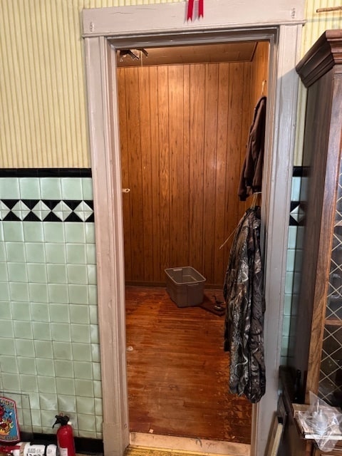 bathroom featuring hardwood / wood-style flooring and wood walls