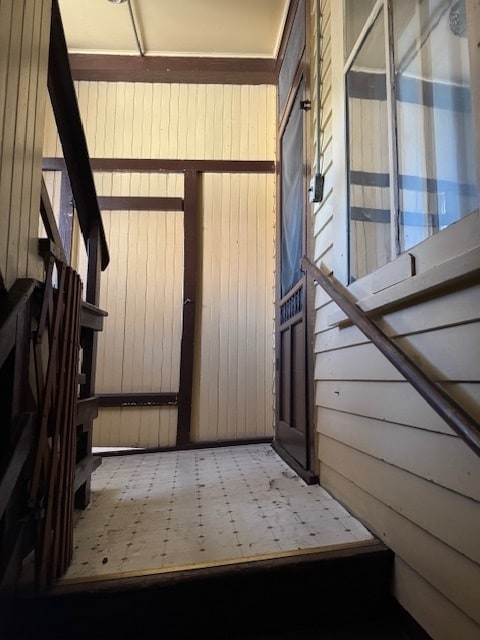 interior space featuring wood walls