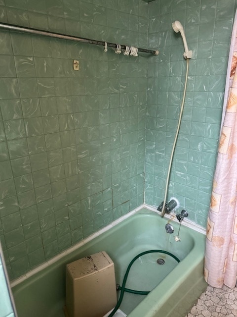 bathroom with shower / bath combination with curtain