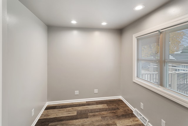 spare room featuring dark hardwood / wood-style flooring