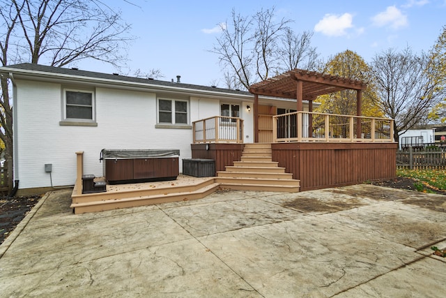 back of house featuring a patio, a pergola, a hot tub, and a deck