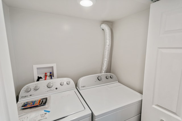 clothes washing area with washing machine and clothes dryer