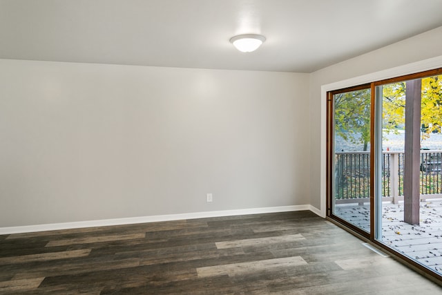 unfurnished room with dark hardwood / wood-style flooring