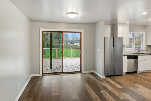 kitchen featuring white cabinets, stainless steel appliances, a wealth of natural light, and sink