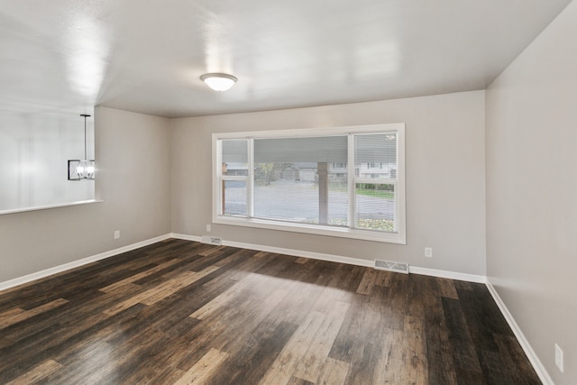 unfurnished room featuring dark wood-type flooring