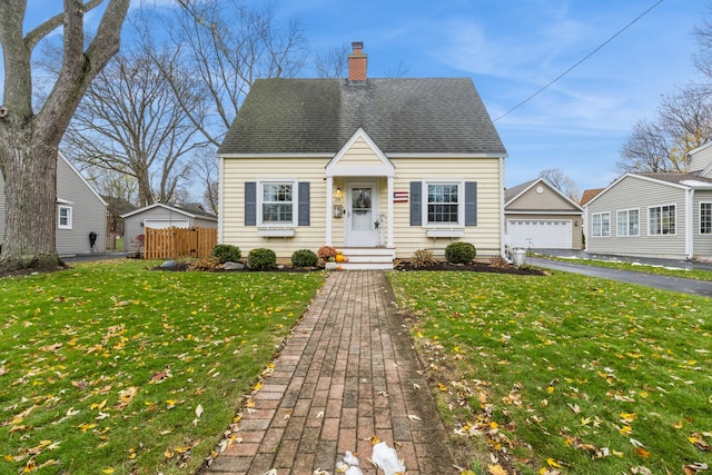 new england style home with a garage and a front lawn