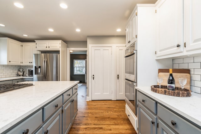 kitchen with gray cabinets, white cabinets, and stainless steel appliances