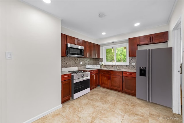 kitchen featuring tasteful backsplash, sink, and appliances with stainless steel finishes