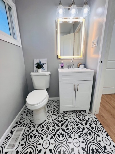 bathroom with vanity, hardwood / wood-style flooring, and toilet