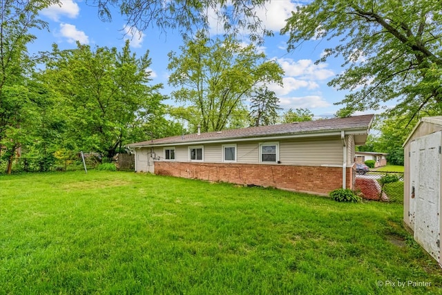 back of house featuring a yard