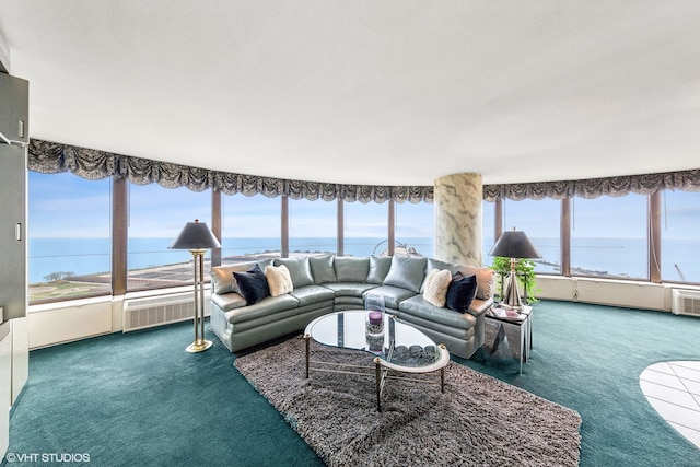 living room with carpet flooring, a wealth of natural light, and a water view