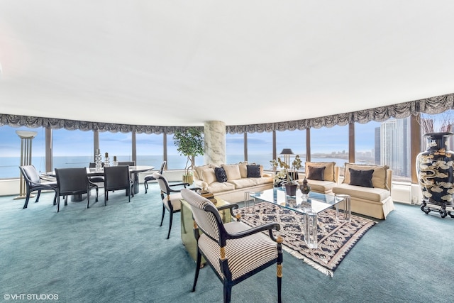 living room with carpet, plenty of natural light, and a water view