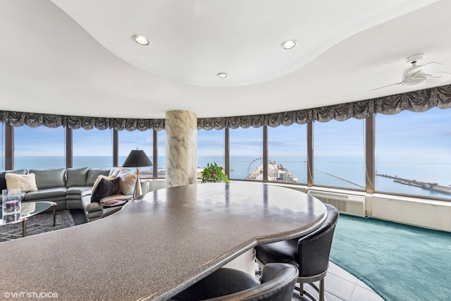 interior space featuring carpet and a water view