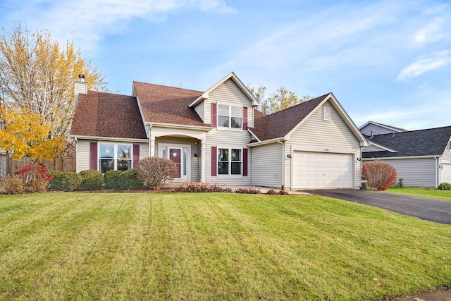 front of property featuring a front yard and a garage