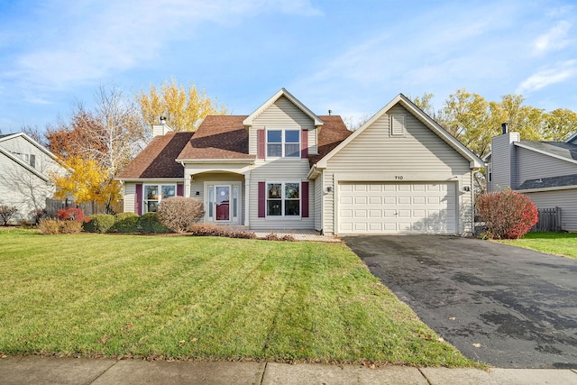 view of property with a garage and a front yard