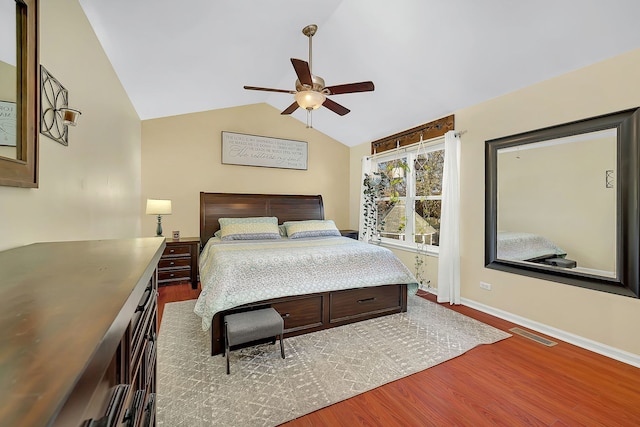 bedroom with hardwood / wood-style flooring, ceiling fan, and vaulted ceiling