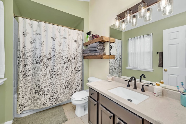 bathroom with toilet, vanity, and tile patterned floors