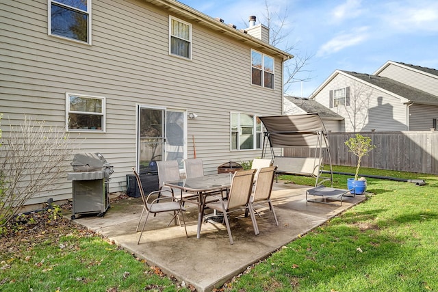 back of house with a lawn and a patio area