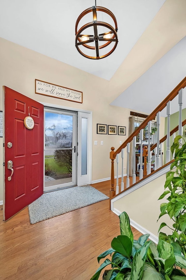 entryway featuring hardwood / wood-style flooring, a healthy amount of sunlight, and an inviting chandelier