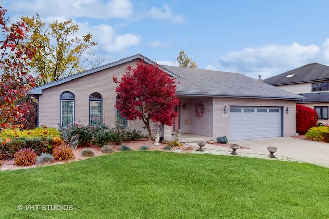 view of front of house with a front yard and a garage