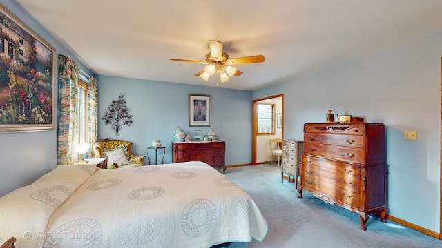 bedroom with ceiling fan and light carpet