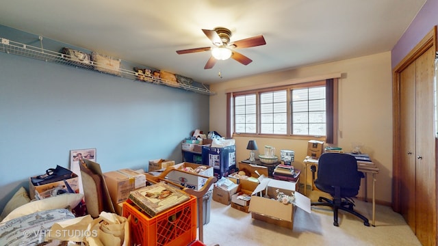 home office featuring light carpet and ceiling fan