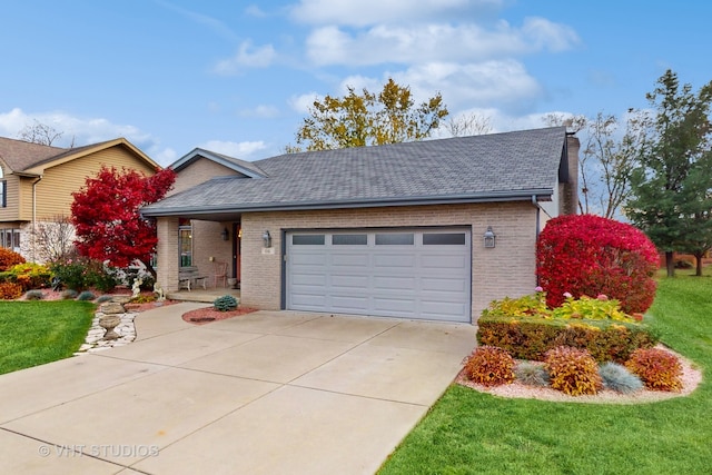 view of front of house featuring a garage and a front yard