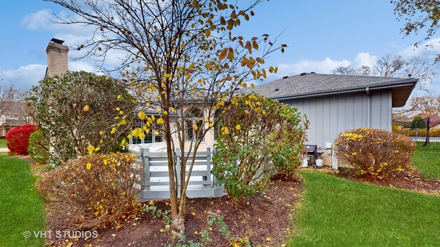 view of side of property with a lawn