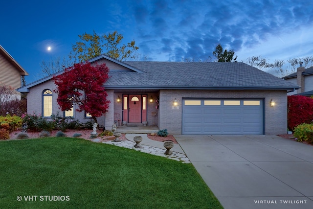 view of front of house featuring a lawn and a garage