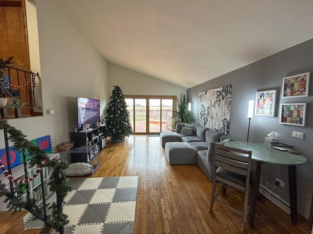 living room featuring high vaulted ceiling and hardwood / wood-style flooring