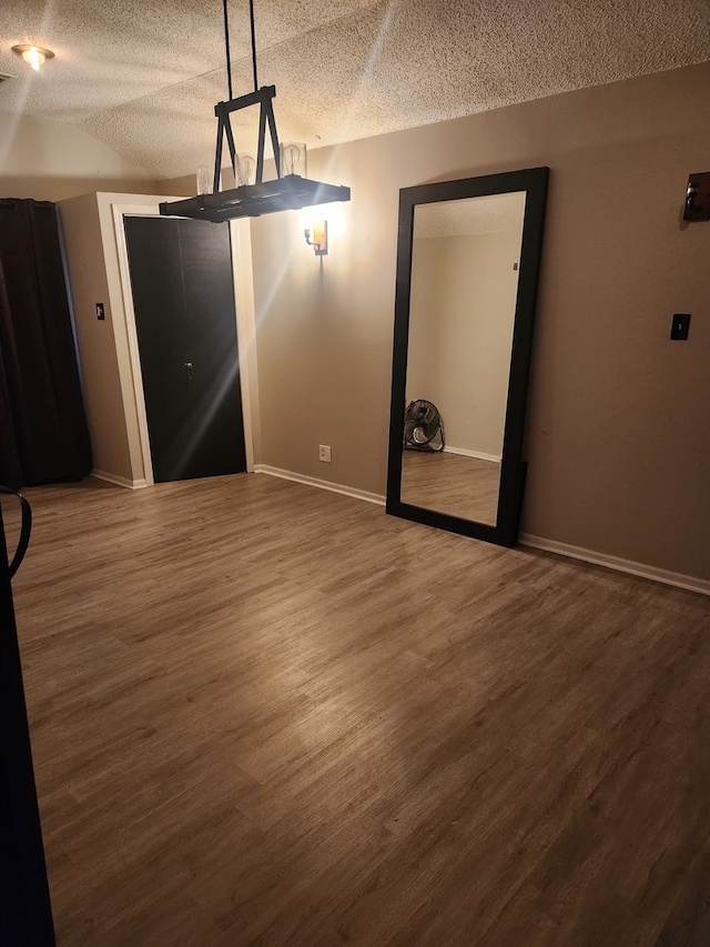 interior space featuring hardwood / wood-style flooring and a textured ceiling