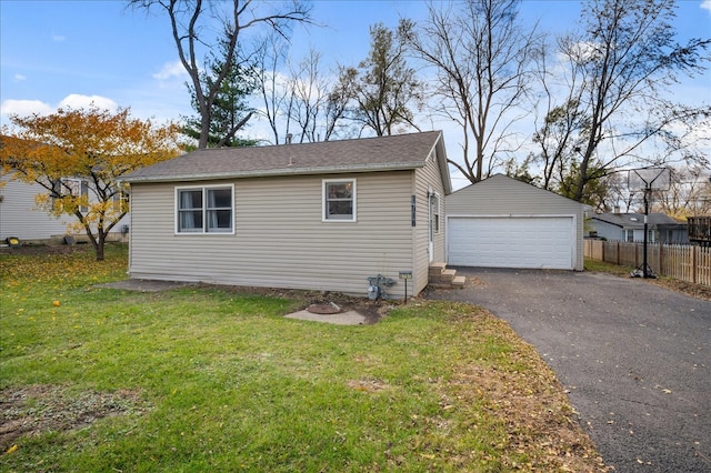 view of property exterior with a lawn, an outbuilding, and a garage