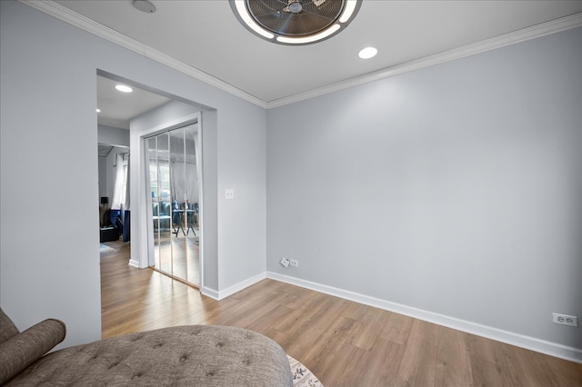 interior space with light wood-type flooring and ornamental molding