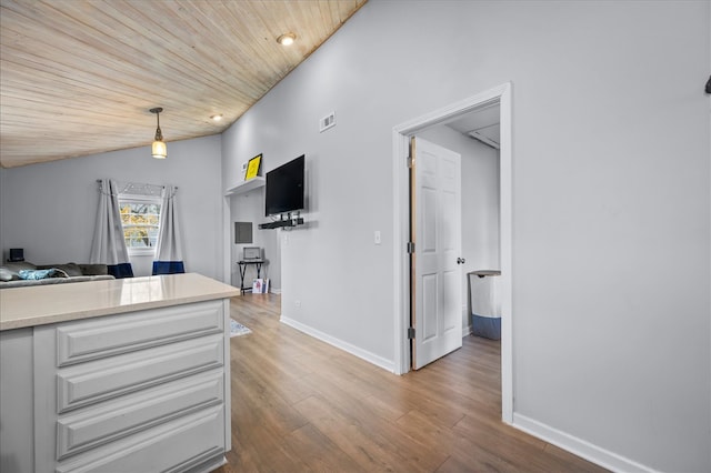 kitchen featuring wooden ceiling, pendant lighting, vaulted ceiling, and light wood-type flooring