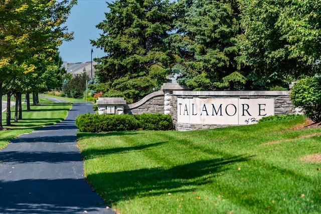 community / neighborhood sign featuring a yard