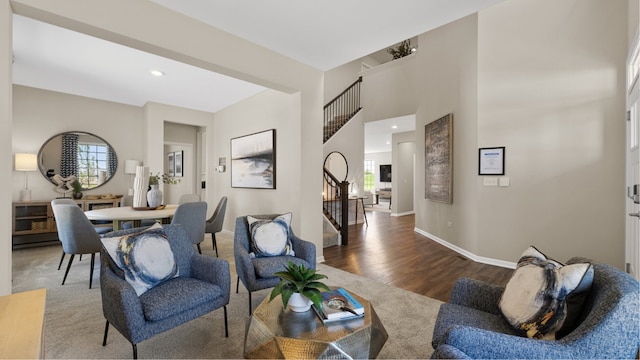 living room featuring plenty of natural light and dark hardwood / wood-style flooring