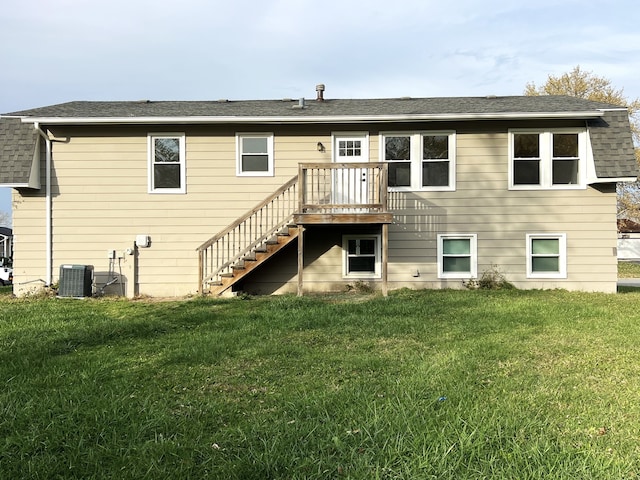 back of house featuring a lawn, central AC unit, and a deck