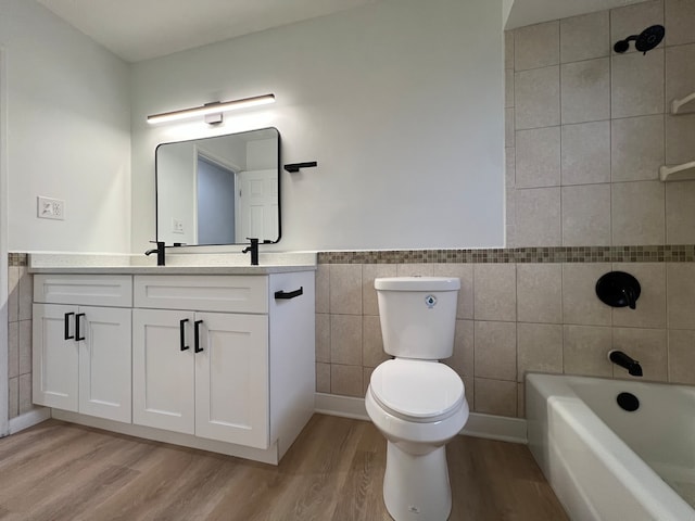 full bathroom featuring wood-type flooring, vanity, toilet, and tile walls