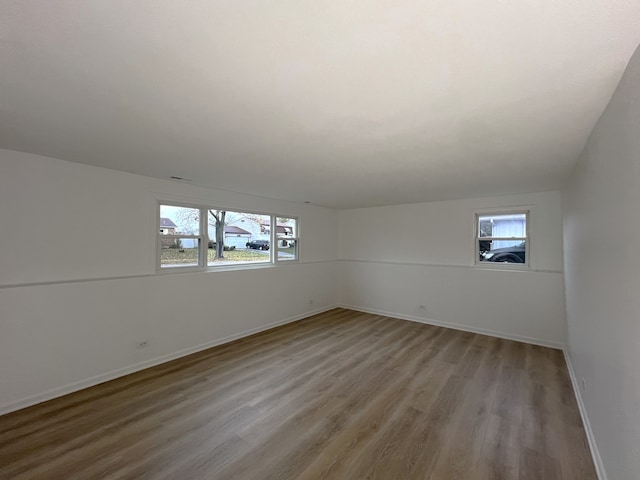 unfurnished room featuring a wealth of natural light and light hardwood / wood-style flooring