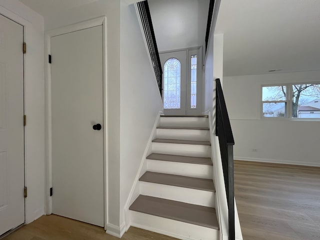 staircase with wood-type flooring