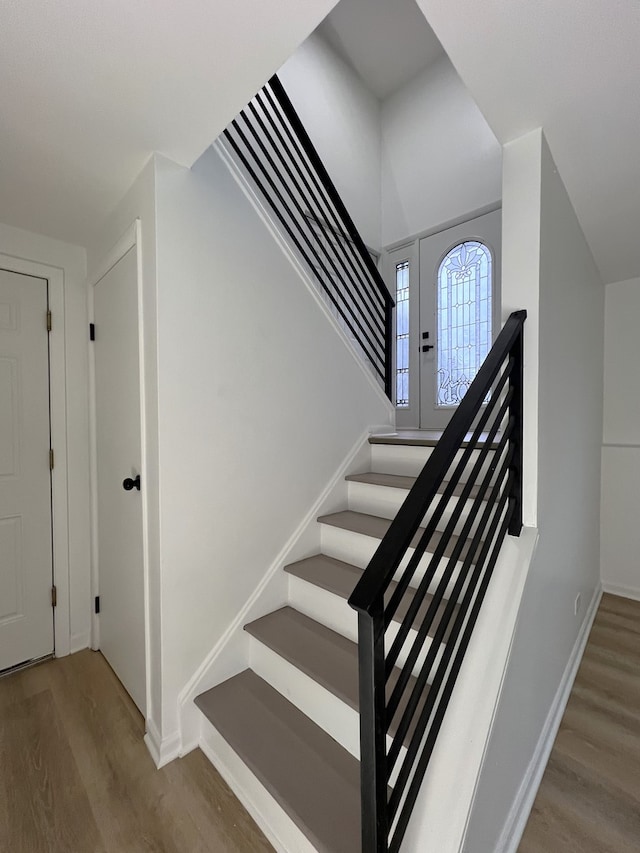 stairs with hardwood / wood-style floors