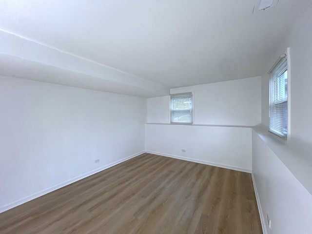 spare room featuring hardwood / wood-style flooring and a wealth of natural light