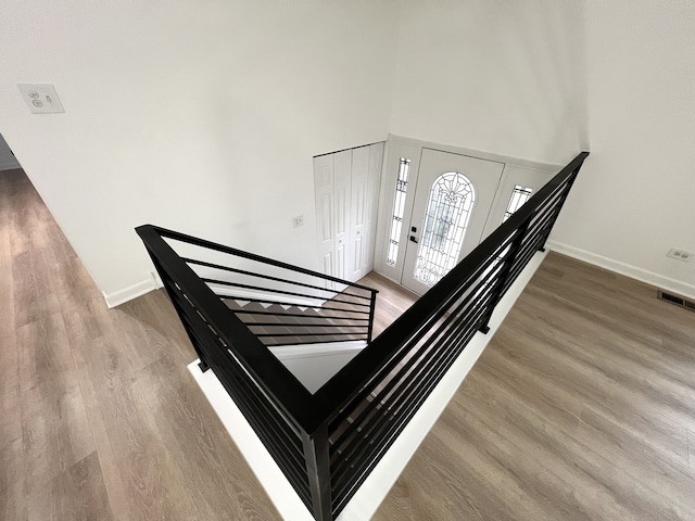 stairway featuring wood-type flooring