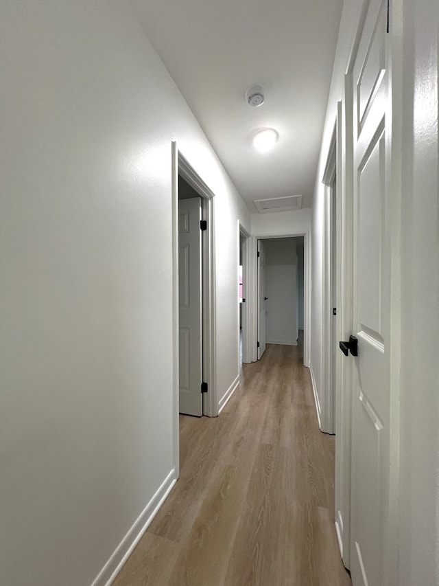 hall with light hardwood / wood-style floors