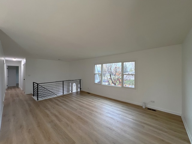 additional living space featuring light hardwood / wood-style flooring